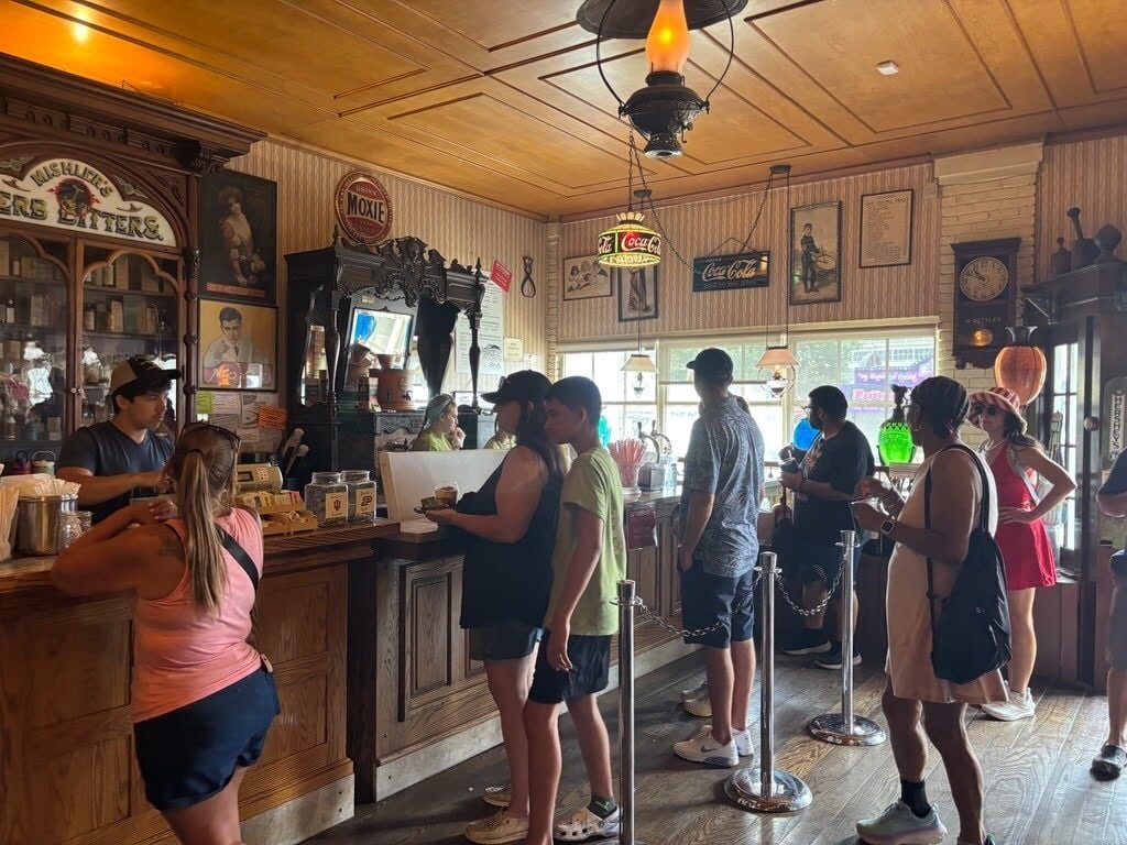Fairgoers wait in line for phosphates, ice-cream sodas and other old-fashioned treats at Hook’s Drugstore Museum at the Indiana State Fairgrounds in August. Photo by Lauren Warner, TheStatehouseFile.com.